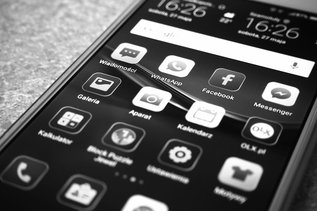Mastering the First Impression: Your intriguing post title goes here Black and white photo of smartphone showing popular app icons like Facebook and WhatsApp.